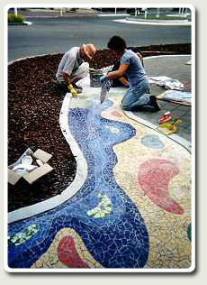 Volunteers laying a Mosaic Mural in Princes Street